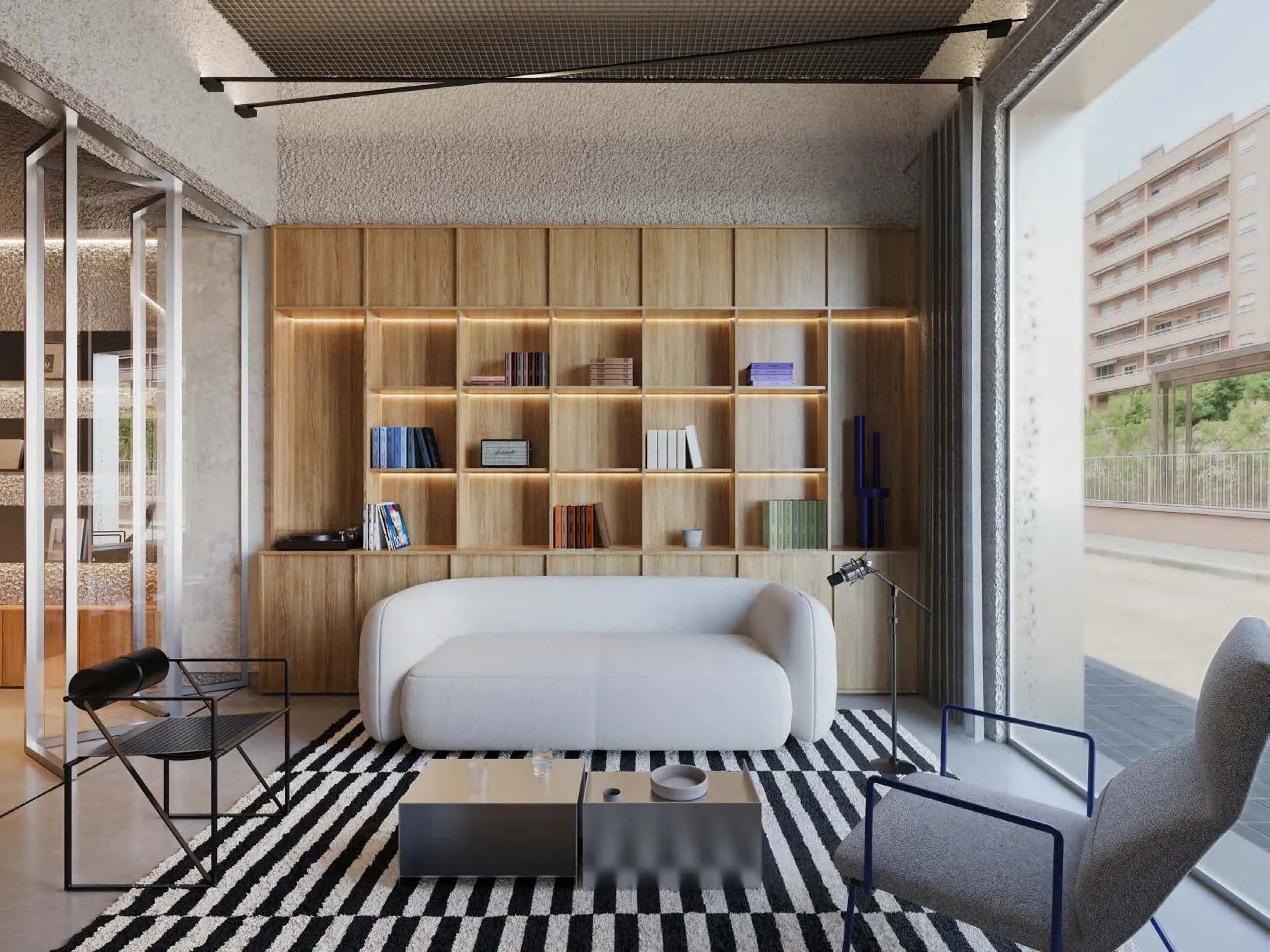 Visualización del lounge con estanterías de libros y vinilos